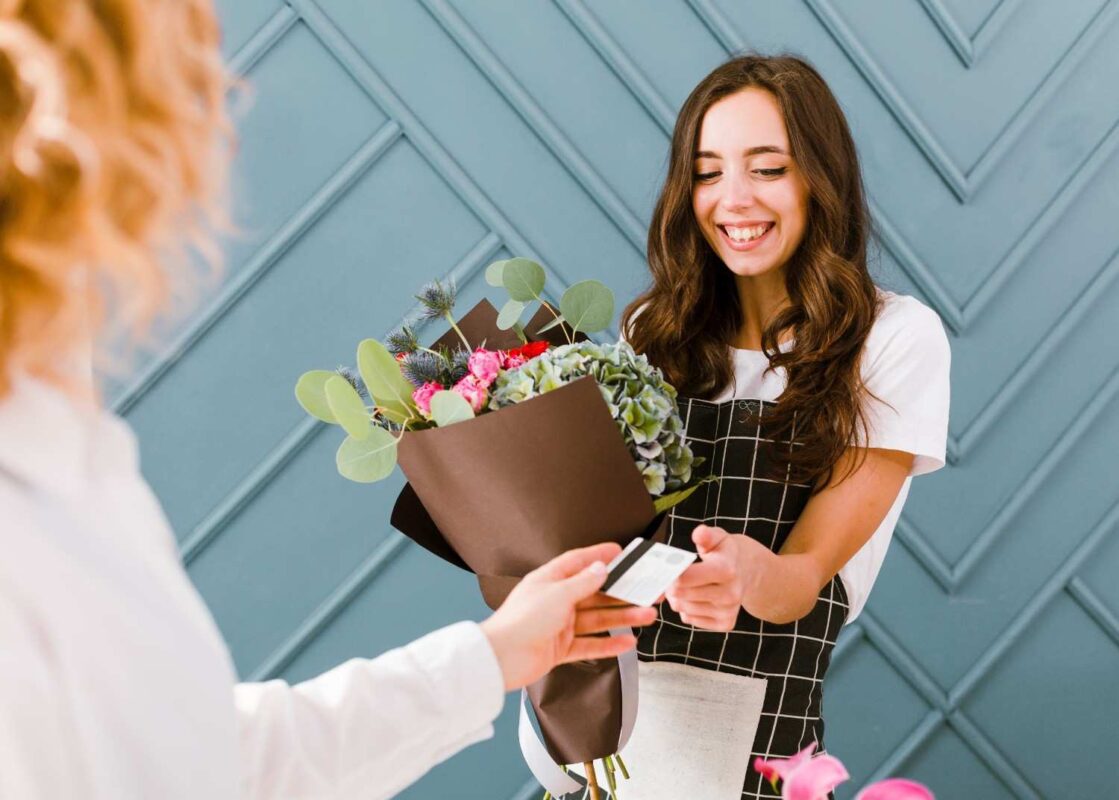 A close up of woman delivering a flower bouquet.