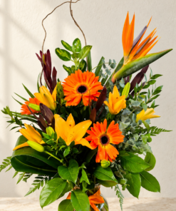 Bright tropical flower arrangement on stone countertop 1.png